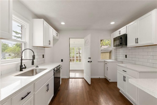 kitchen featuring dark wood-style floors, recessed lighting, a sink, backsplash, and black appliances