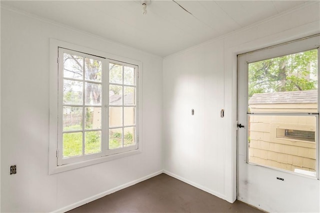 empty room with a healthy amount of sunlight and crown molding