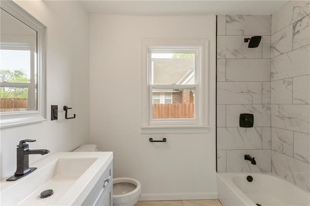 full bath with washtub / shower combination, baseboards, vanity, and toilet