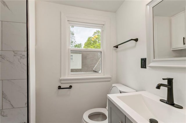 bathroom featuring toilet and vanity