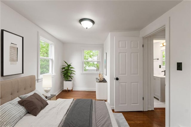 1133 E 75th St, Kansas City, MO 64131 - bedroom with dark wood-style flooring, baseboards, and a sink