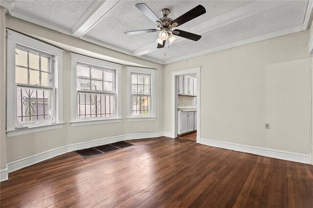 spare room with visible vents, baseboards, ceiling fan, dark wood-type flooring, and a textured ceiling