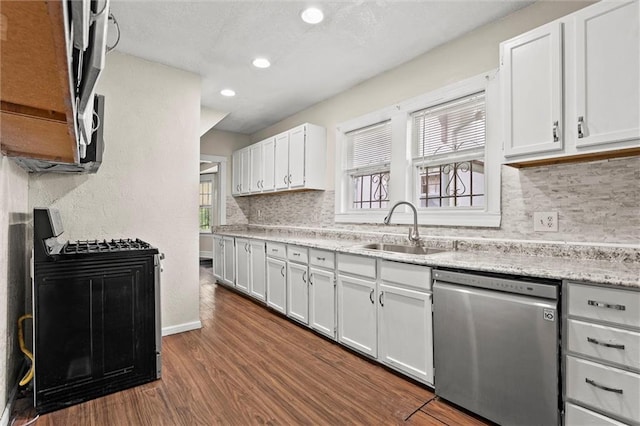 kitchen featuring decorative backsplash, dark wood-style floors, light countertops, a sink, and appliances with stainless steel finishes