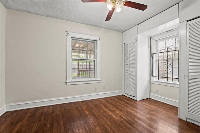 unfurnished bedroom featuring baseboards, a textured ceiling, ceiling fan, and hardwood / wood-style floors