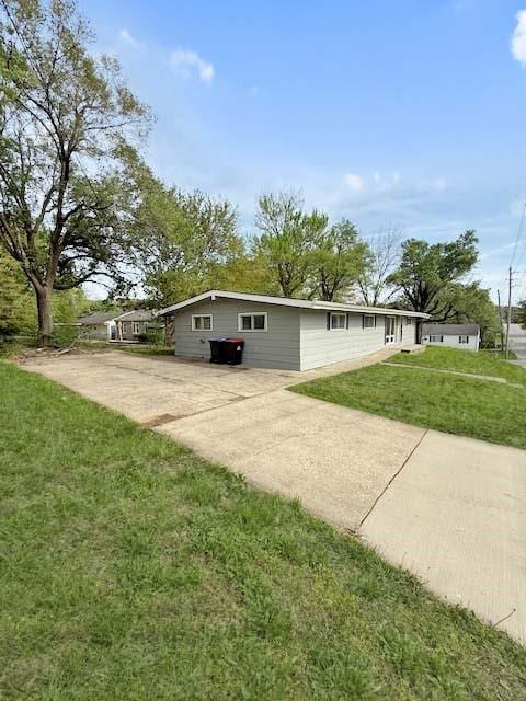 view of property exterior featuring a lawn