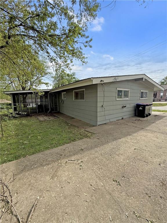 back of property with a sunroom