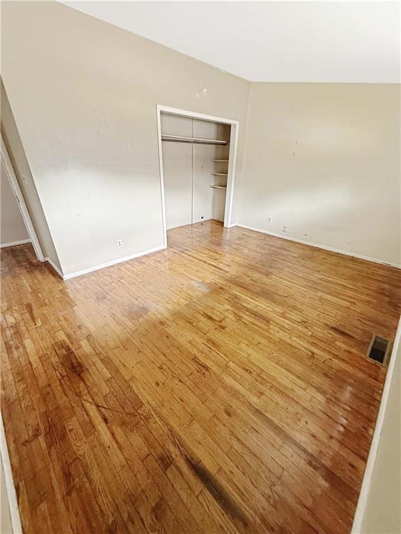 unfurnished bedroom with light wood-style floors, baseboards, a closet, and visible vents