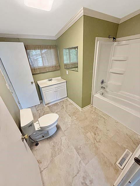 full bathroom with vanity, shower / bathtub combination, baseboards, visible vents, and ornamental molding