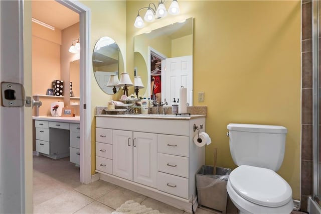 bathroom featuring tile patterned floors, vanity, a shower with door, and toilet