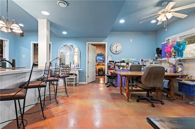 office featuring recessed lighting, concrete floors, and ceiling fan with notable chandelier