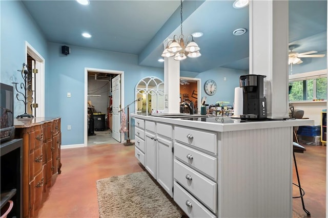 bathroom featuring ceiling fan with notable chandelier, concrete flooring, vanity, baseboards, and recessed lighting