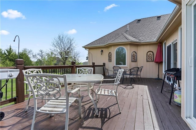 wooden deck featuring outdoor dining space