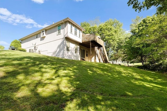 22716 E 29th Street Lane Ct S, Blue Springs, MO 64015 - back of property with stairway, a wooden deck, a lawn, and central AC unit