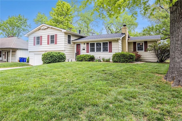 tri-level home featuring an attached garage, a front yard, and a chimney
