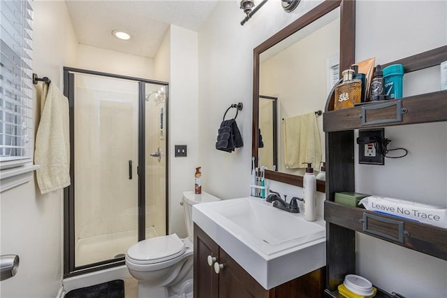 bathroom with vanity, toilet, recessed lighting, and a stall shower