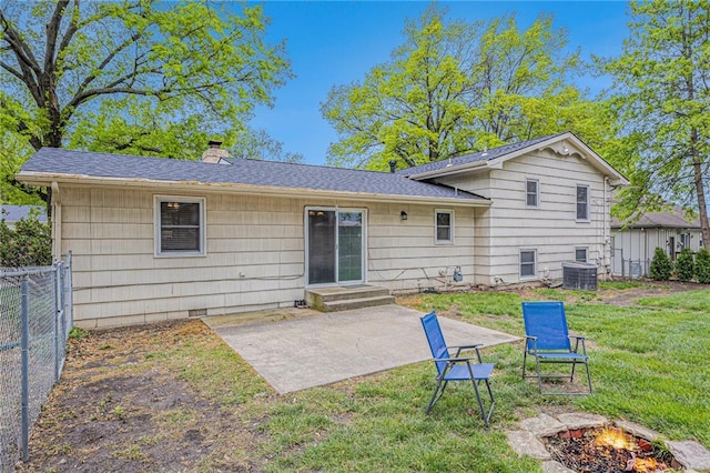 rear view of house with a fire pit, fence, a patio, a chimney, and a yard