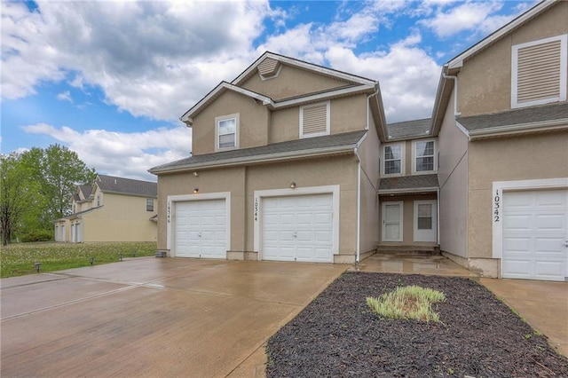 view of front of property featuring an attached garage, stucco siding, and driveway