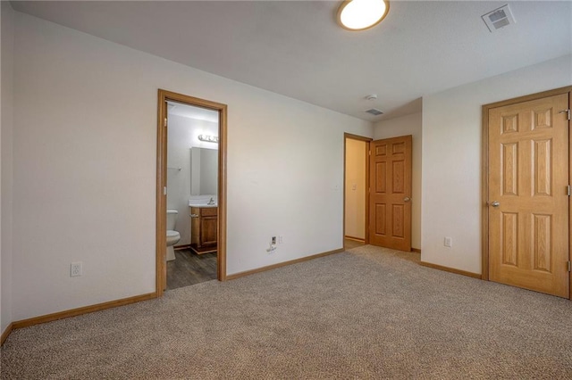 unfurnished bedroom with baseboards, carpet flooring, connected bathroom, and visible vents