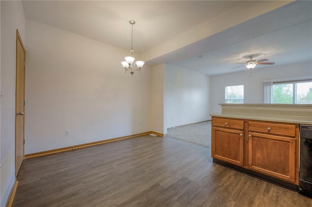 kitchen with baseboards, dark wood-type flooring, light countertops, brown cabinets, and hanging light fixtures