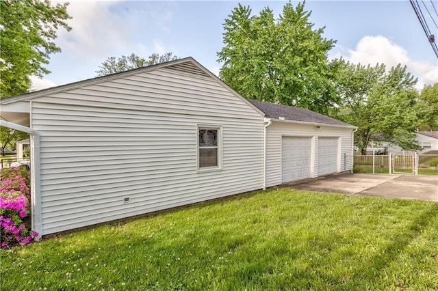 view of property exterior featuring a yard, an attached garage, and fence