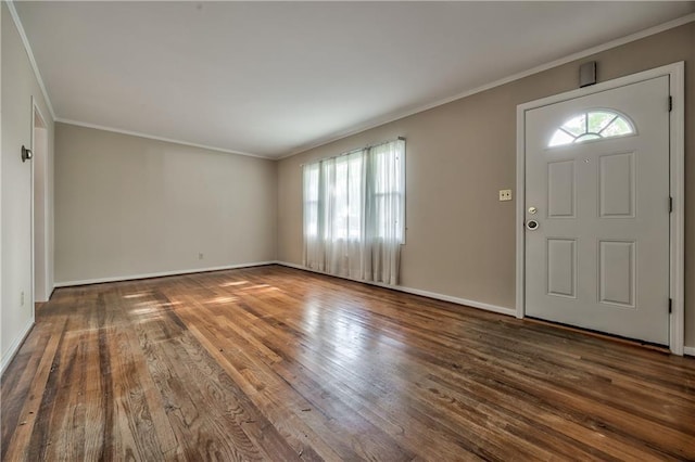 foyer entrance with crown molding, baseboards, and wood finished floors
