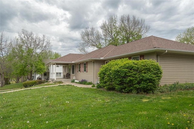 rear view of property with a porch and a yard