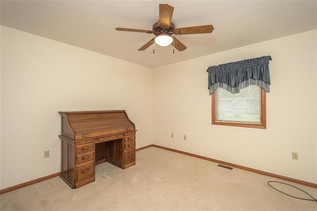 unfurnished bedroom featuring light carpet, baseboards, and ceiling fan
