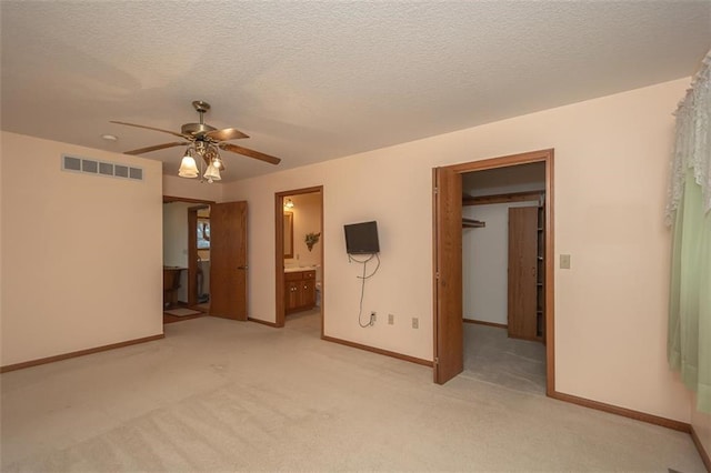 interior space with connected bathroom, visible vents, light carpet, and baseboards