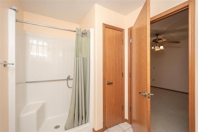 bathroom featuring tile patterned flooring, a ceiling fan, and a shower with curtain