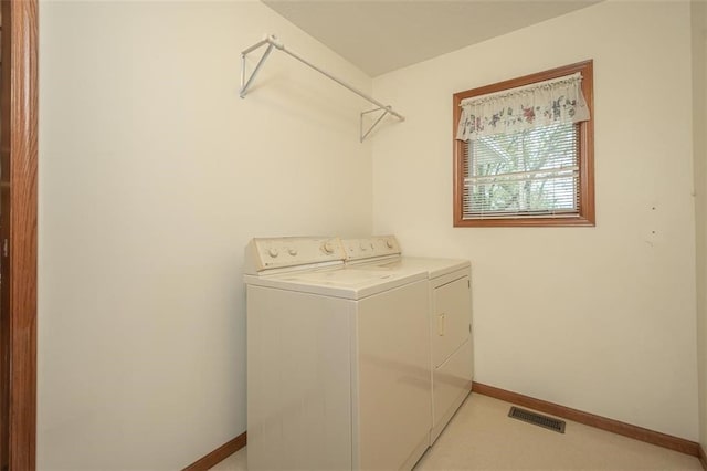 laundry room featuring separate washer and dryer, baseboards, visible vents, and laundry area