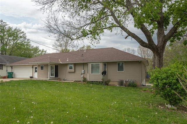 rear view of house with cooling unit, a lawn, driveway, and an attached garage