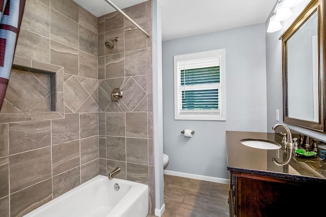 full bathroom featuring baseboards, shower / tub combination, vanity, and toilet