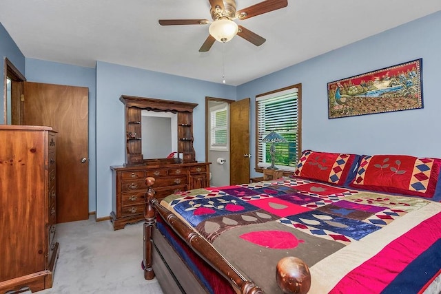 bedroom featuring light carpet and a ceiling fan