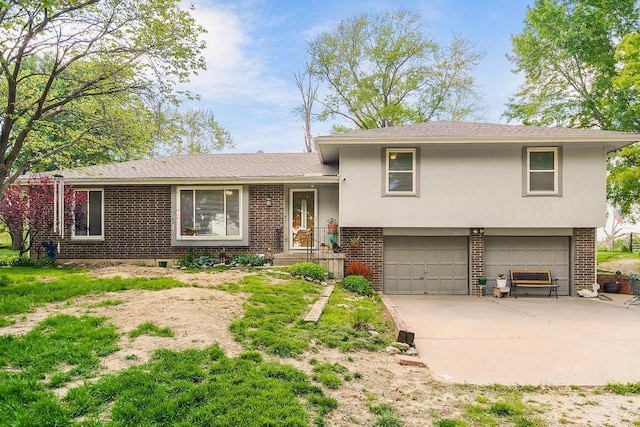18171 198th St, Tonganoxie, KS 66086 - tri-level home featuring brick siding, a garage, and driveway