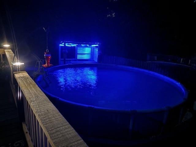 pool at twilight featuring an outdoor pool
