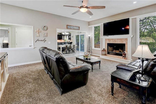 carpeted living area with baseboards, a ceiling fan, recessed lighting, and a tile fireplace