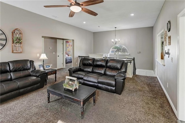 carpeted living area featuring ceiling fan with notable chandelier and recessed lighting