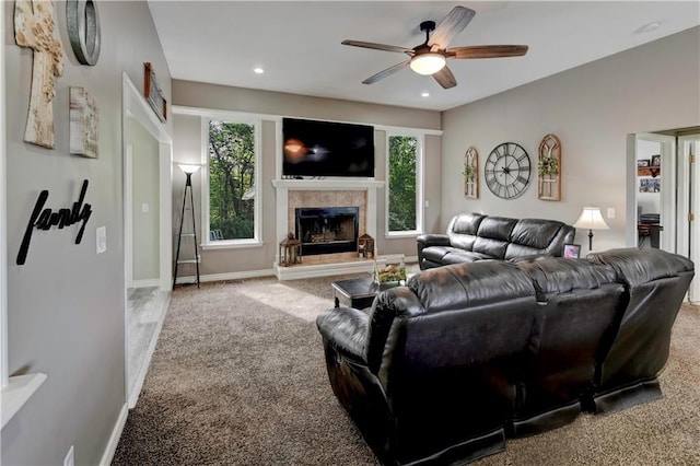 carpeted living area with baseboards, ceiling fan, recessed lighting, and a tile fireplace