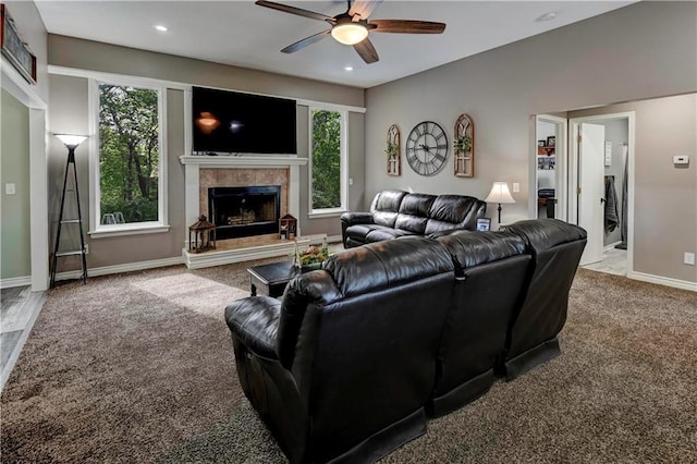 carpeted living area featuring baseboards, ceiling fan, recessed lighting, and a tile fireplace