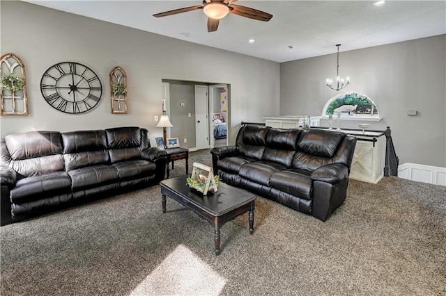 carpeted living room featuring recessed lighting and ceiling fan with notable chandelier