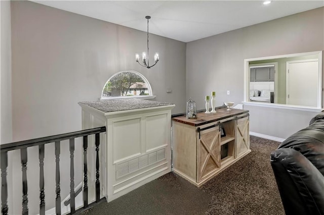 bar featuring baseboards, dark carpet, a chandelier, and decorative light fixtures