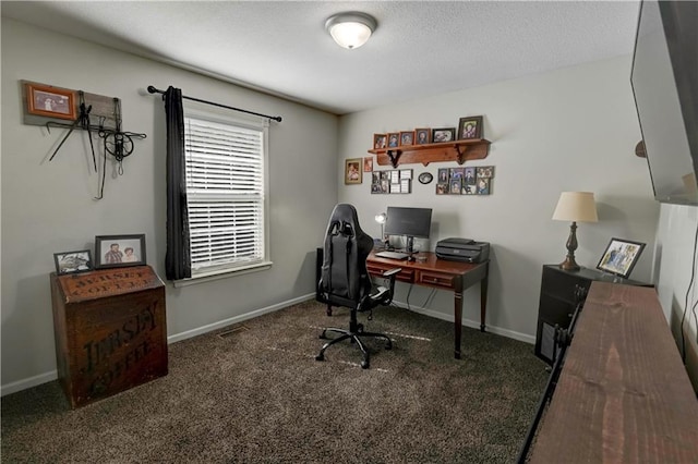 carpeted office featuring a textured ceiling and baseboards