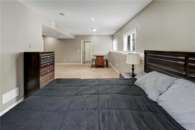 bedroom featuring baseboards, dark colored carpet, and visible vents