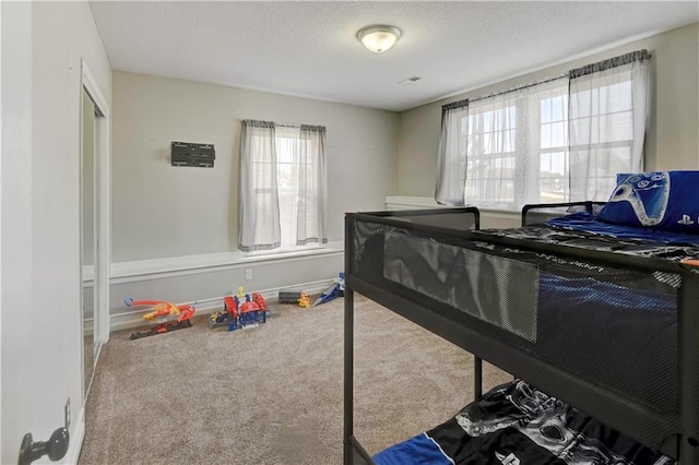 bedroom with carpet flooring and a textured ceiling