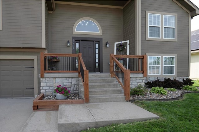 doorway to property featuring a garage and concrete driveway