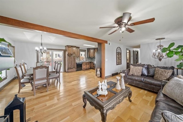 living room with baseboards, ceiling fan with notable chandelier, and light wood finished floors