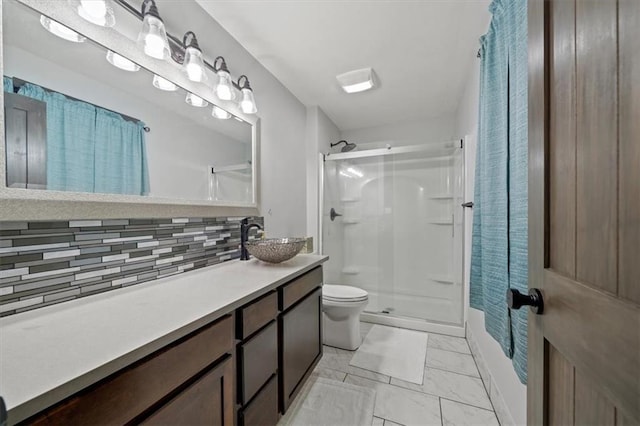 bathroom with decorative backsplash, a shower stall, marble finish floor, toilet, and vanity