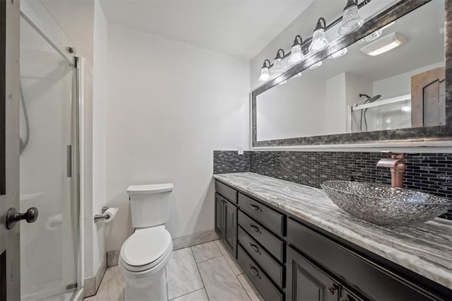 full bath featuring decorative backsplash, a stall shower, toilet, vanity, and marble finish floor