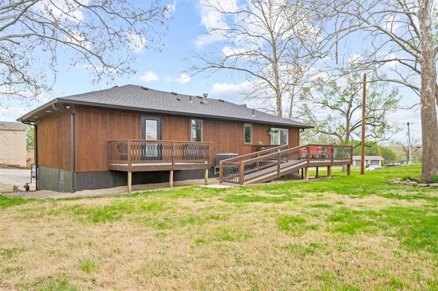 back of house with a deck and a lawn