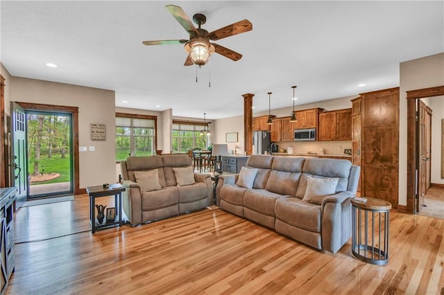 living area with recessed lighting, a ceiling fan, and light wood finished floors